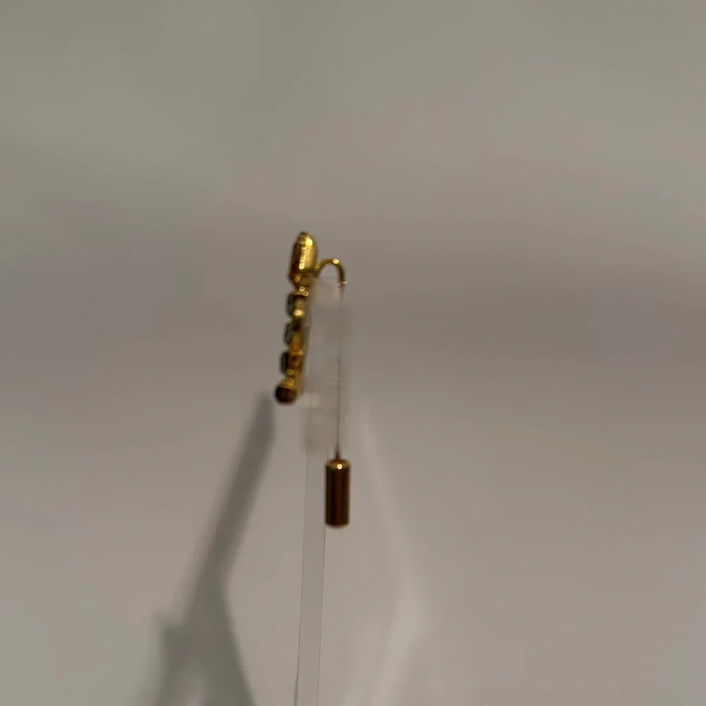 Elegant Gold and Green Brooch with Candle Design